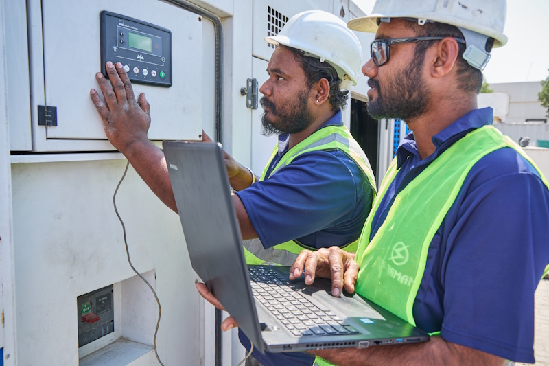 Al Tamam certified technicians calibrating generator controller