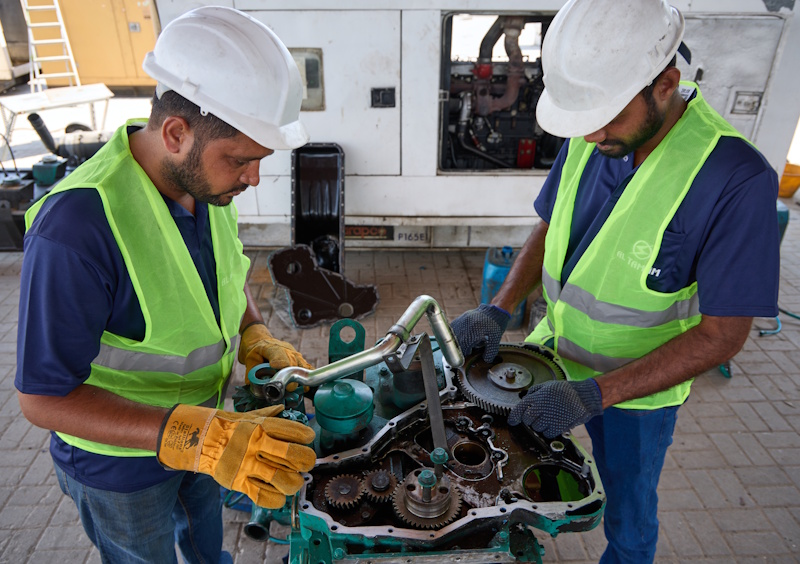 Mechanical engineers performing precision timing gear overhaul